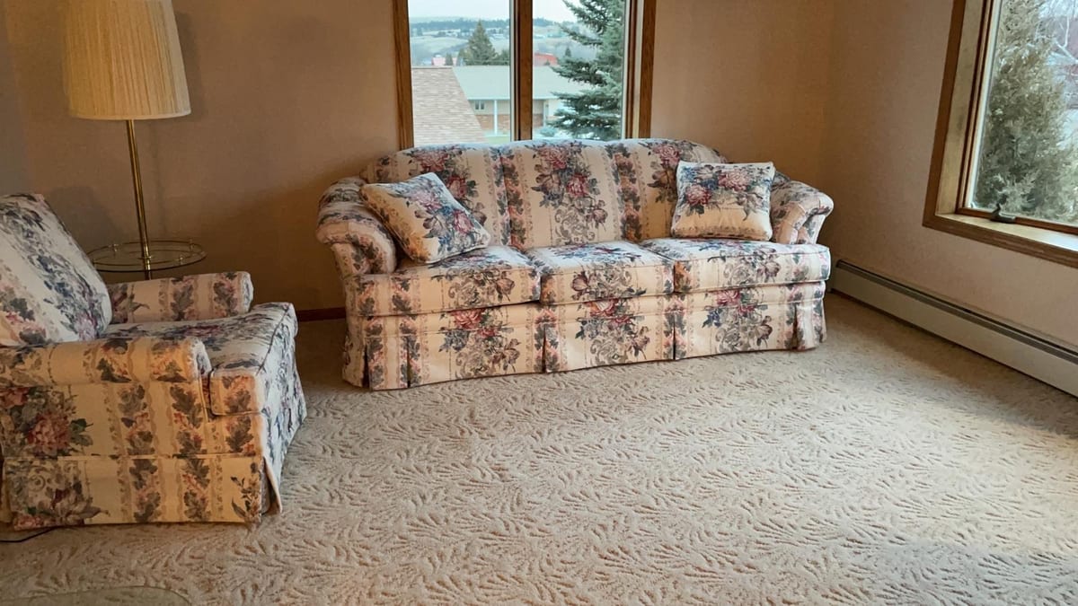 Sitting room with the family's inherited sofas before the project, Montana, USA