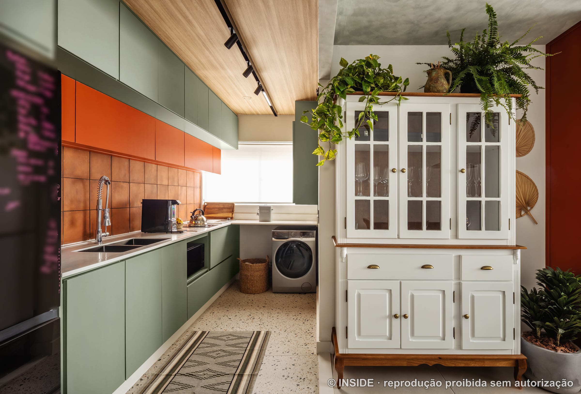 Cozinha com marcenaria verde, armários laranja, revestimento acobreado e cristaleira branca, projeto INSIDE
